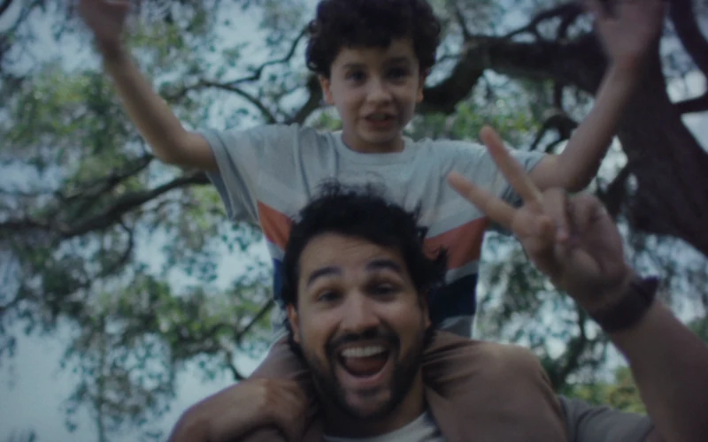 A man carries a child on his shoulders in Ad Council’s Lost in a Flash