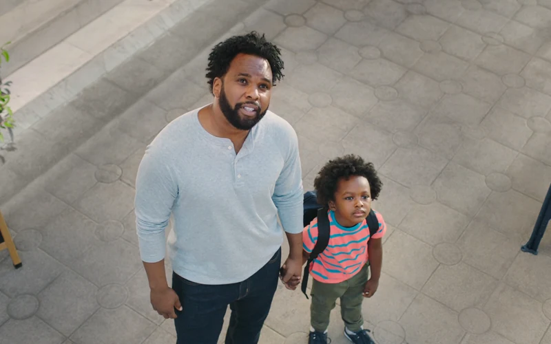 A father and daughter look up together on a city street in Citi’s This Changes Everything