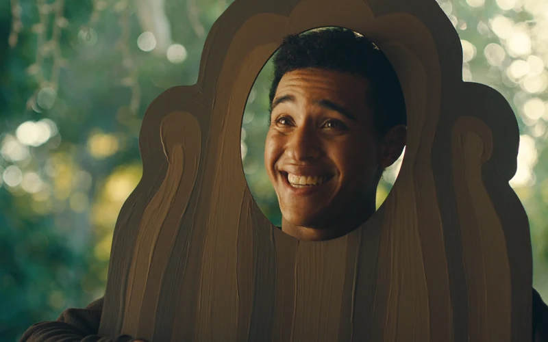 A smiling man in a giant pecan costume in Fisher Nuts’ It’s in the Bag