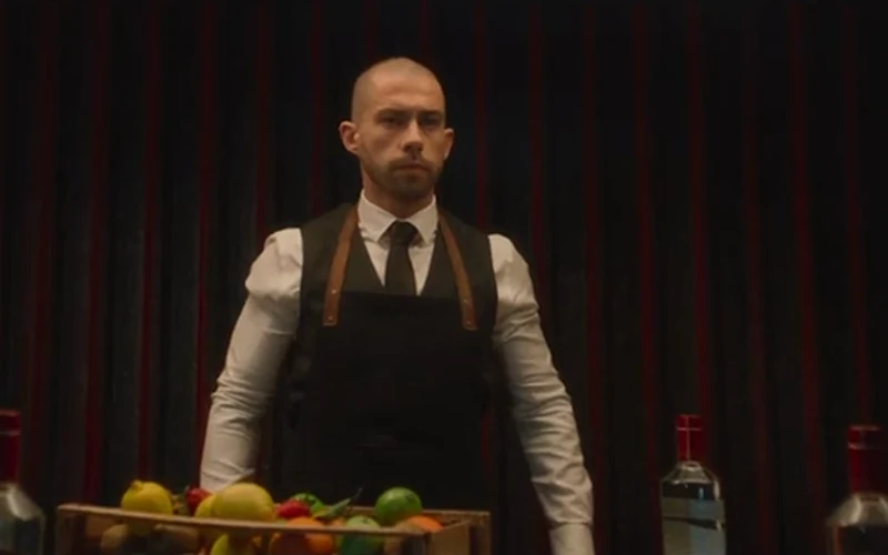 A bartender presents a tray in Smirnoff’s Secret Service