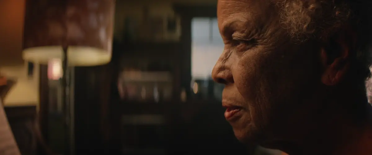 A woman beside a piano in The Gift of Music, directed by Nate Townsend for Pianos for People