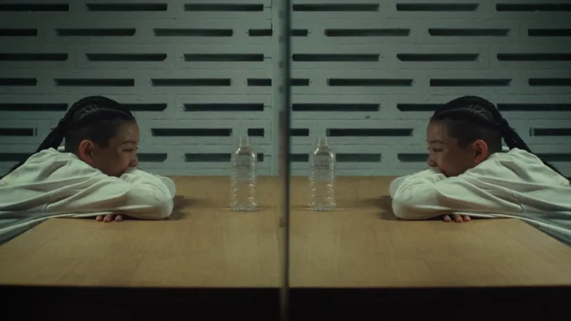A young dancer faces her reflection across a table in Super Kids.