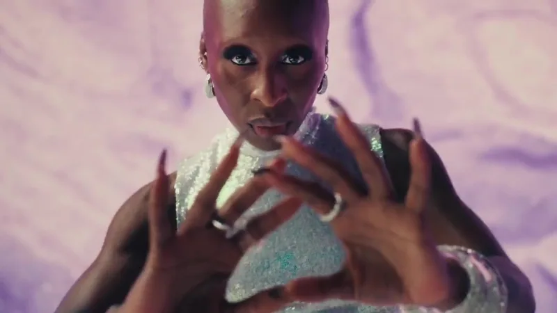 Cynthia Erivo performs in a metallic dress against purple light.