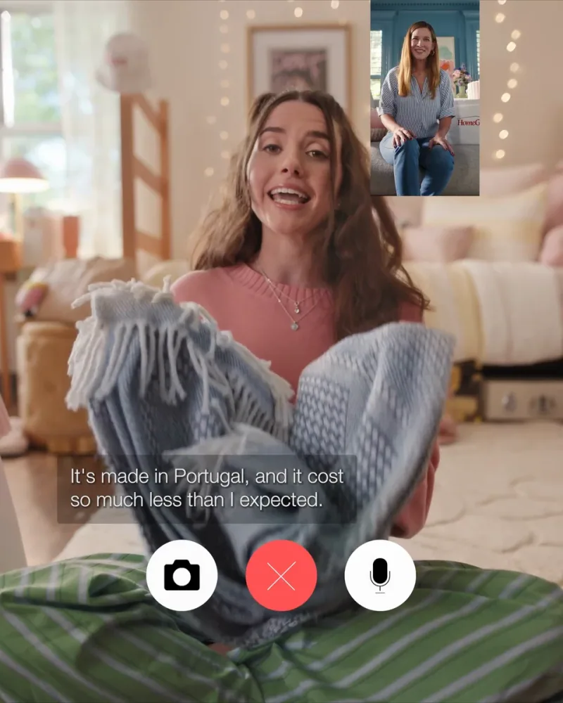 A student displays a blue throw during a video call home in HomeGoods Show and Tell