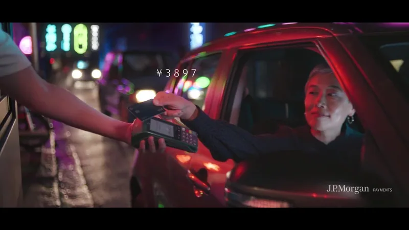 A passenger makes a card payment from a car window in J.P. Morgan: Anthem.