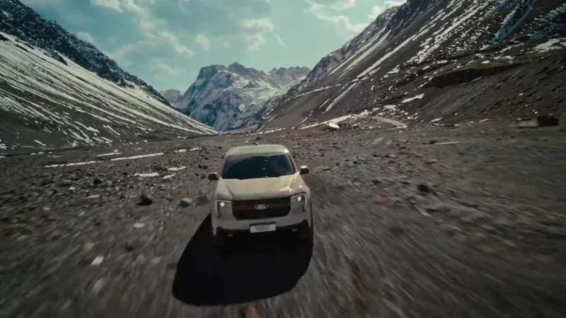 A white pickup truck approaches through a mountain valley.
