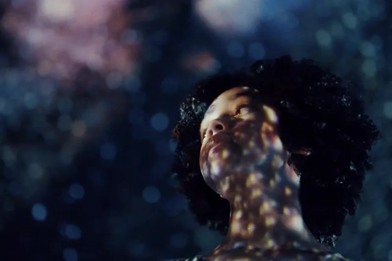 Woman illuminated by shimmering reflected light
