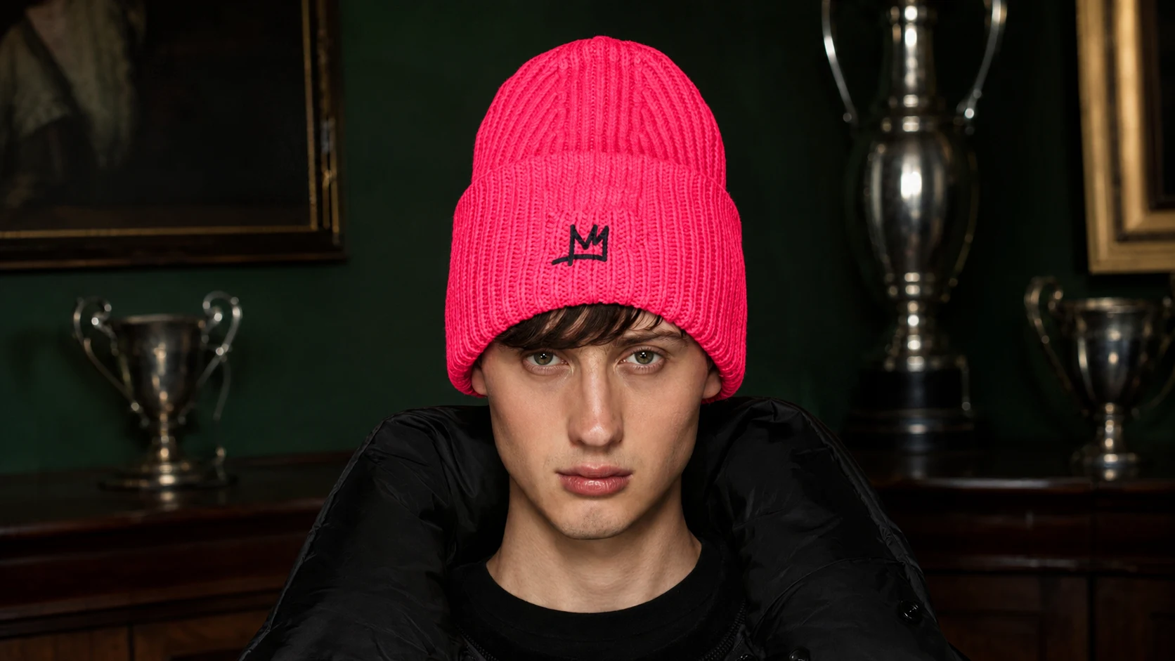 Model wearing the hot-pink ELEANOR beanie with an embroidered black crown